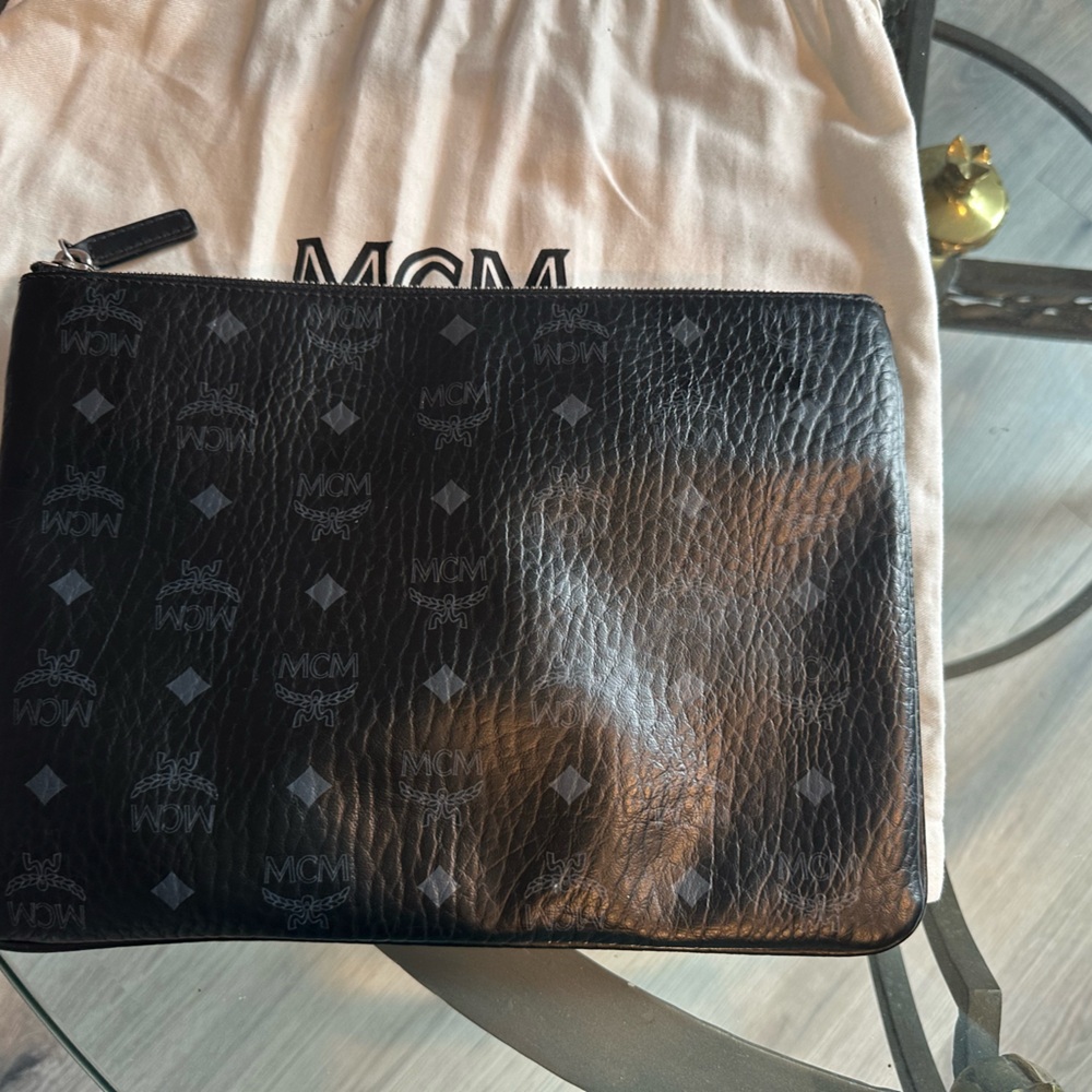 This stylish MCM Crossbody Bag features a sleek and sophisticated design
